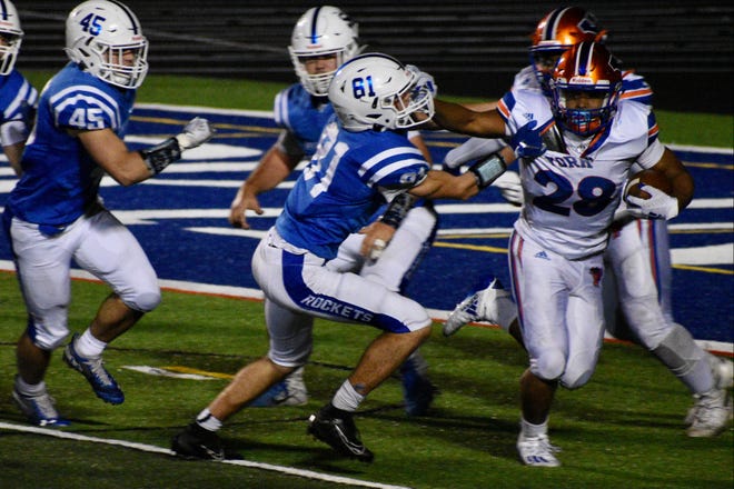 York High sophomore running back Jahiem White stiff arms a Spring Grove defender last season. White ran for 120 yards in the 21-7 victory, scored a two-point conversion and threw a 68-yard touchdown pass.