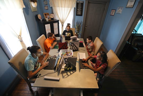 The Sepulveda kids all at work as remote learning continues for each of them in the dining room of their home in Rochester Friday, Sept. 25, 2020. Pictured clockwise from bottom left are Reinaldo, ninth grade; Jeremiah, eighth grade; Reina, a senior, Jacob, fifth grade, and Rihanna, seventh grade. 