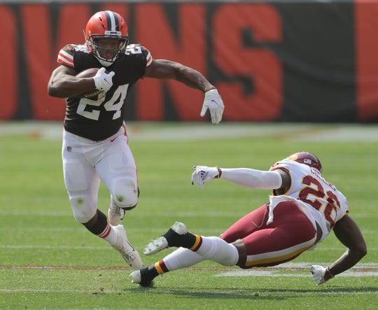 Cleveland Browns' Nick Chubb gets past Washington's Landon Collins during a second quarter run on Sunday, Sept. 27, 2020 in Cleveland, Ohio at FirstEnergy Stadium.  [Phil Masturzo/ Beacon Journal]