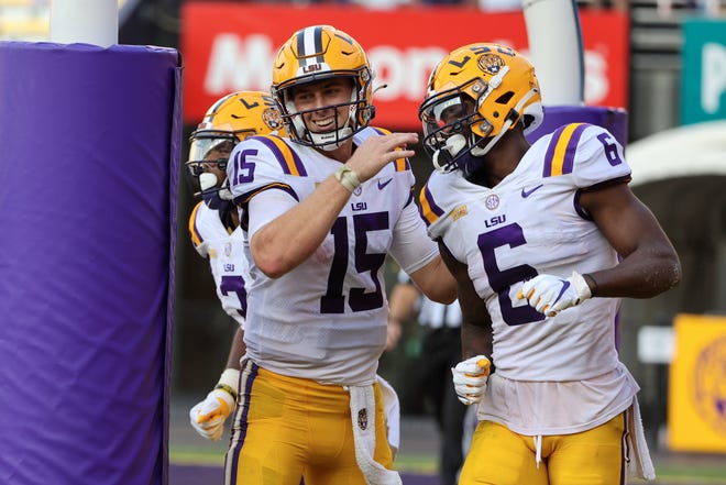 Sep 26, 2020; Baton Rouge, Louisiana, USA; LSU Tigers quarterback Myles Brennan (15) celebrates with wide receiver Terrace Marshall Jr. (6) after a touchdown against the Mississippi State Bulldogs during the second half at Tiger Stadium. Mandatory Credit: Derick E. Hingle-USA TODAY Sports
