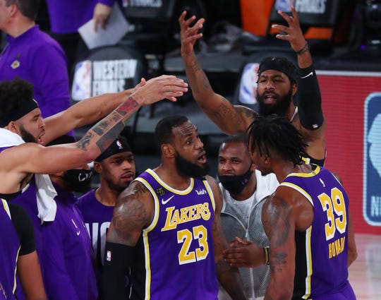 Los Angeles Lakers forward LeBron James celebrates with teammates during the fourth quarter of Game 5 against the Denver Nuggets.
