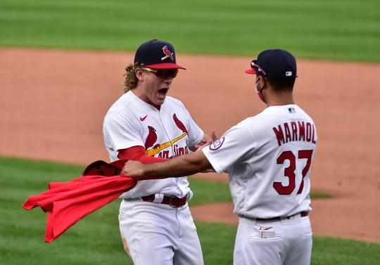 St. Louis Cardinals center fielder Harrison Bader celebrates with bench coach Oliver Marmol (37) after the team defeated the Milwaukee Brewers to clinch a postseason spot.