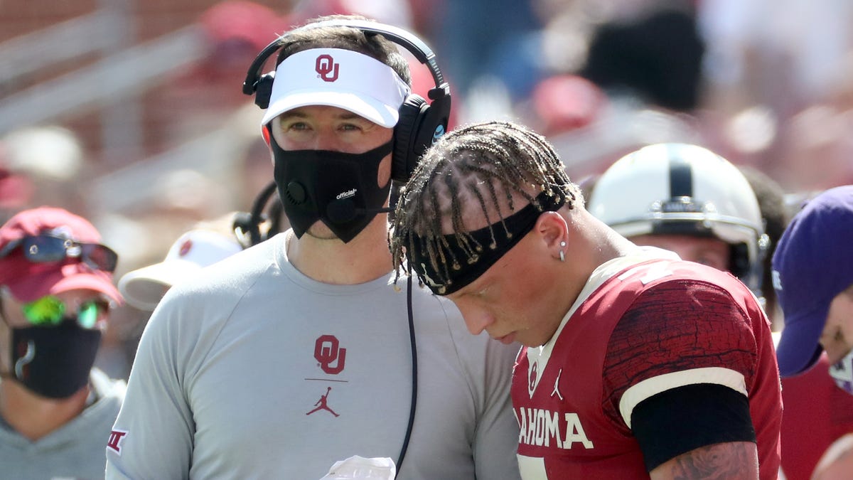 Oklahoma quarterback Spencer Rattler speaks with head coach Lincoln Riley during the second half of the Sooners' loss against Kansas State.
