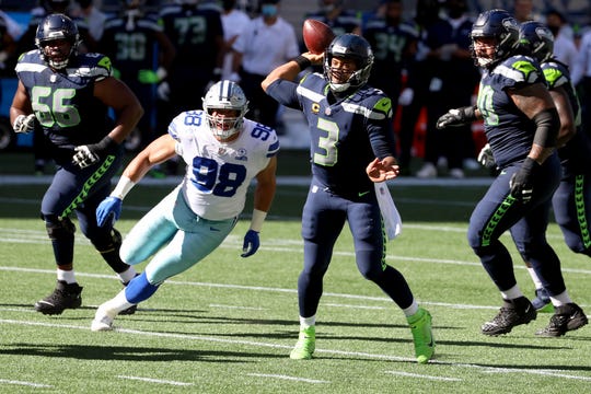 Russell Wilson #3 of the Seattle Seahawks looks to pass against the Dallas Cowboys during the second quarter in the game at CenturyLink Field on September 27, 2020 in Seattle, Washington.