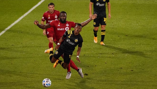 Toronto FC forward Jozy Altidore (17) fouls Columbus Crew midfielder Luis Diaz (12) and is given a yellow card in the first half on Sunday night at Pratt & Whitney Stadium in Hartford, Conn.
