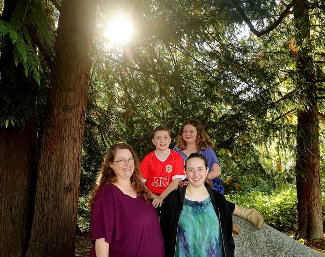 Krista Radeke and her kids Maddie, 10, Kassie, 12, and Abbie, 17, pose for a portrait at a park near their East Bremerton home on Monday, Sept. 28, 2020. 