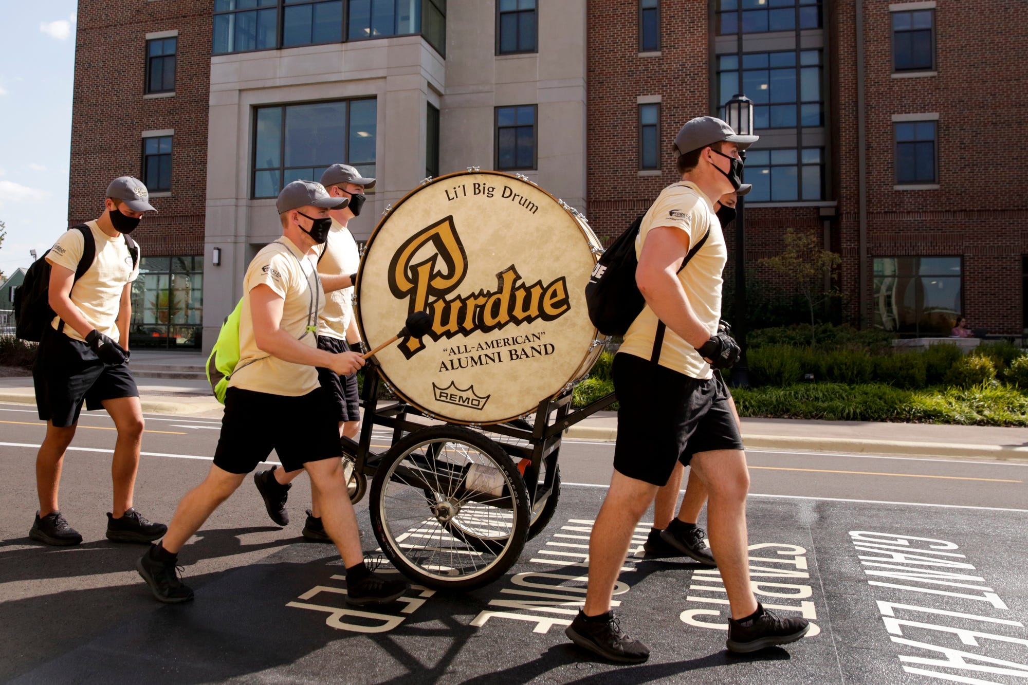 The Pudue University marching band's Li'l Big Drum is wheeled through West Lafayette on Friday.