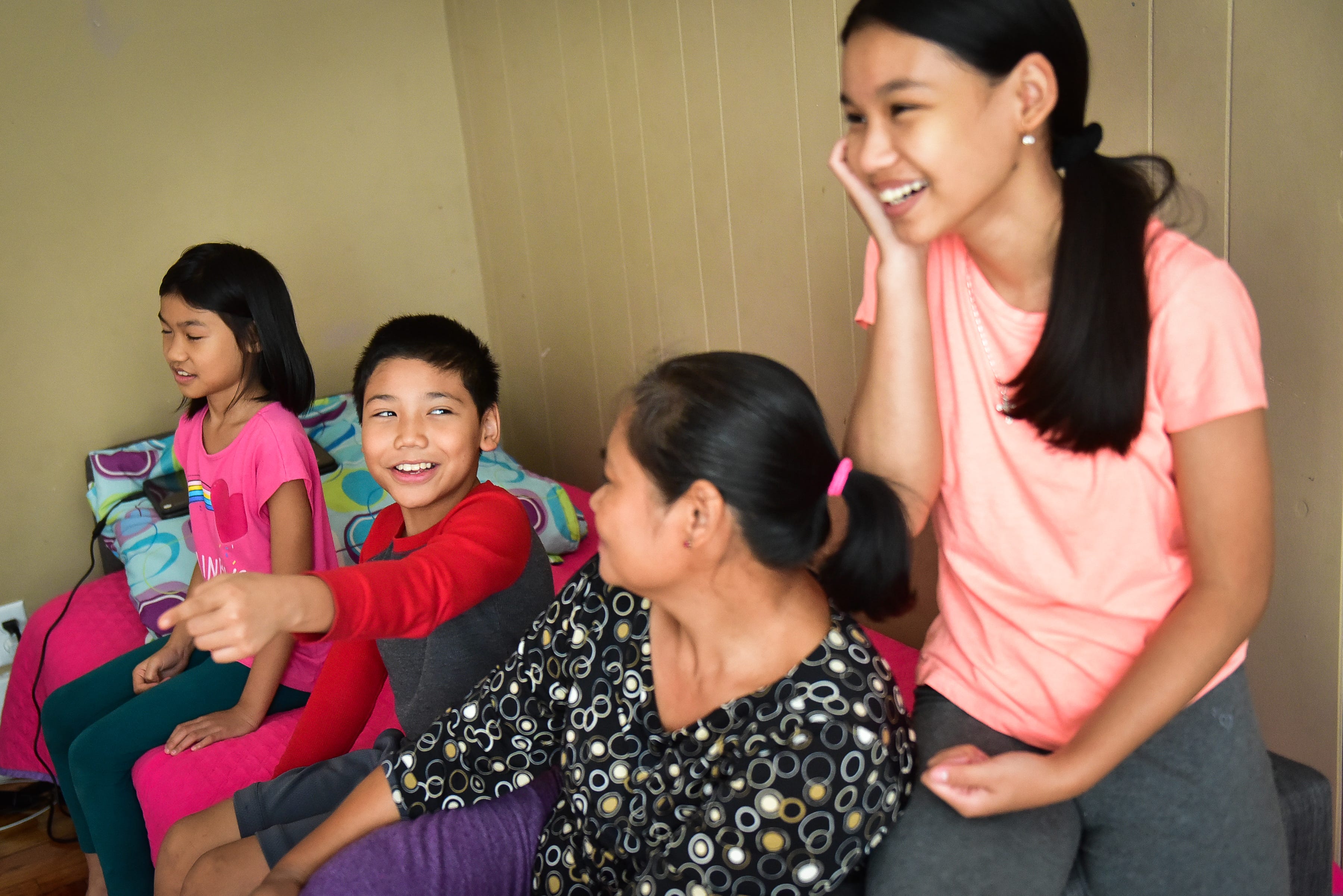 Saw Kler Kaw Htoo, left center, points to one of his sisters and laughs while talking about what it's like to attend classes from home on Thursday, Sept. 24, 2020, in Utica.