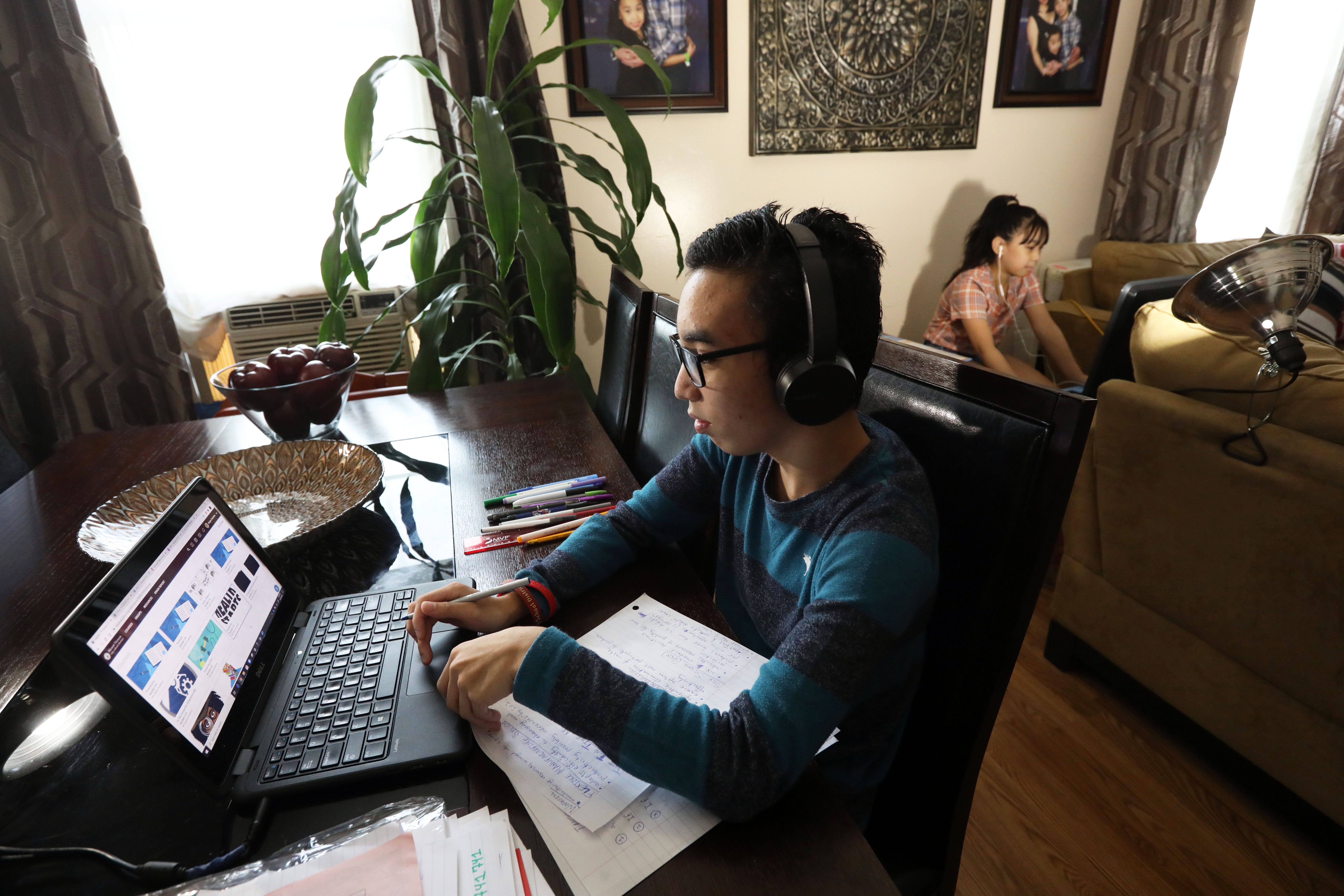 High school junior Bryan Santiago, 16, works on an assignment as his sister, fifth-grader Julia Santiago, 10, works at her station at home in Mount Vernon Sept. 25, 2020. The Mount Vernon City School District started the year with virtual classes due to the COVID-19 pandemic.