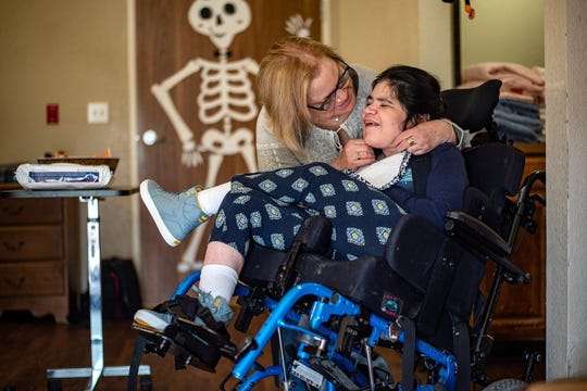 Sue Schnars embraces her daughter, Ivana, in her room at the Pflugerville Health Care Center in 2018.
