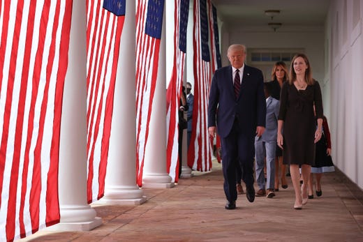 President Donald Trump, first lady Melania Trump, 7th U.S. Circuit Court Judge Amy Coney Barrett, and her family walk along the Rose Garden Colonnade after Trump announced Barrett as his nominee for the Supreme Court at the White House Sept. 26, 2020 in Washington, DC.