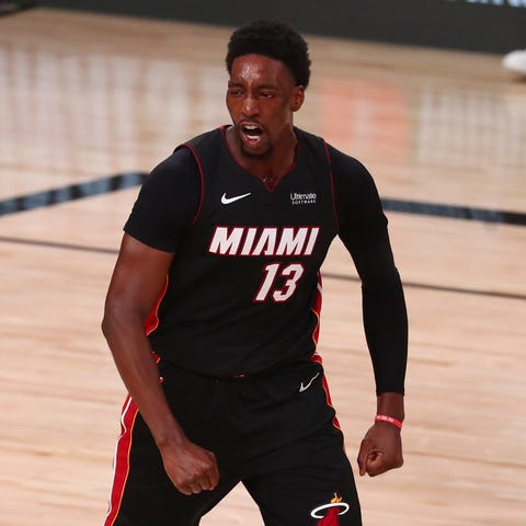 Miami Heat forward Bam Adebayo flexes after dunkin