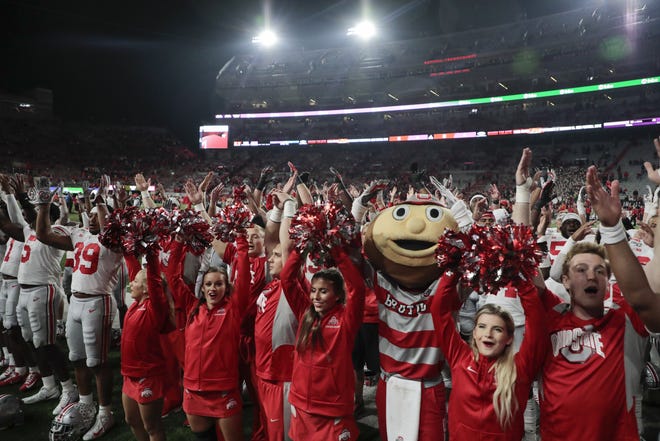 Ohio State Buckeyes players and cheerleaders sing "Carmen Ohio" following the Buckeyes' 48-7 victory against the Nebraska Cornhuskers during a NCAA Division I football game on Saturday, September 28, 2019 at Memorial Stadium in Lincoln, Nebraska. [Joshua A. Bickel/Dispatch]