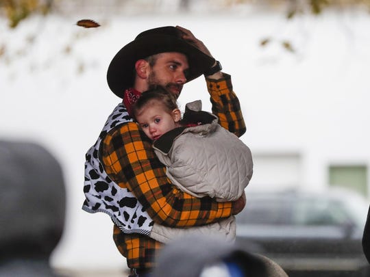 Stephen Brooks, dressed as "Toy Story's" Woody for Halloween, holds Juliet during the 2019 Safe Night Halloween at the Indiana State Fairgrounds. Because of the coronavirus pandemic, the event will not happen this year.