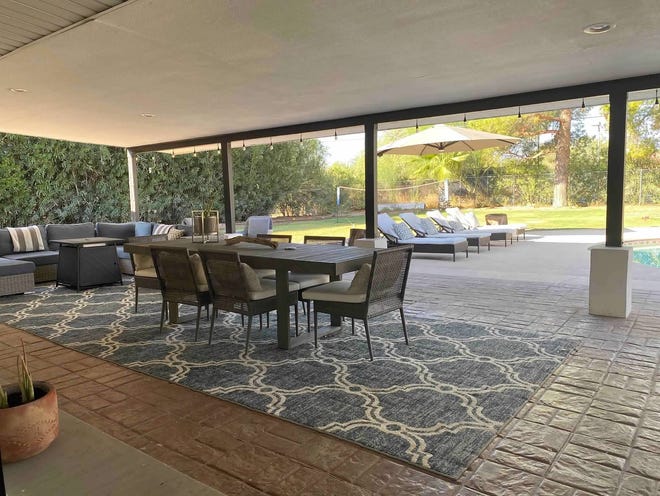 A view of the patio and large grass area from the house.