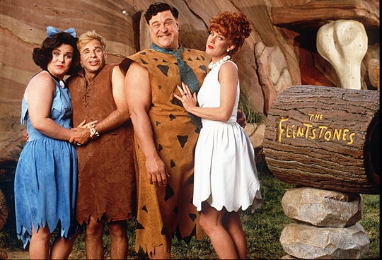 Rosie O'Donnell (Betty), left, Rick Moranis (Barney), John Goodman (Fred) and Elizabeth Perkins (Wilma) starred in 1994's "The Flintstones."