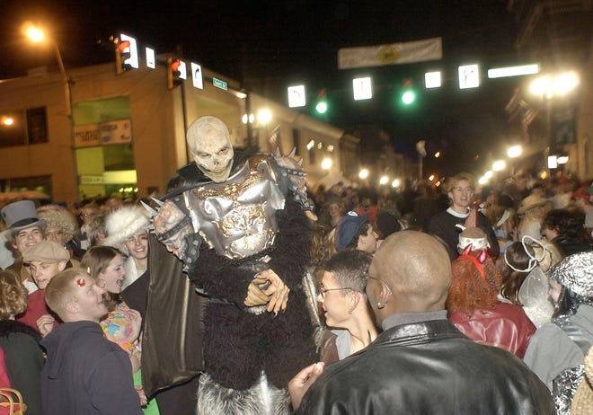 In this November 2002 file photo, crowds celebrate during the Halloween party in Athens. Due to the COVID-19 pandemic, the popular annual block party has been canceled.
