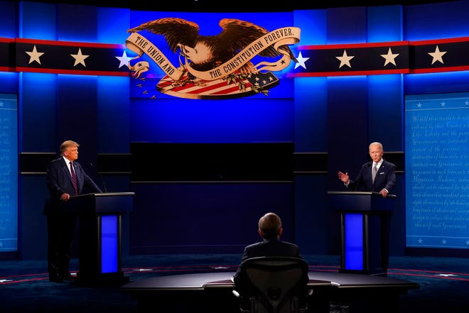 President Donald Trump, left, and Democratic presidential candidate former Vice President Joe Biden, right, with moderator Chris Wallace, center, of Fox News during the first presidential debate Tuesday, Sept. 29, 2020, at Case Western University and Cleveland Clinic, in Cleveland, Ohio. (AP Photo/Patrick Semansky)