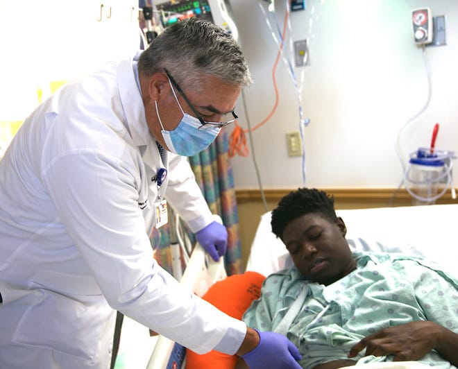 Dr. Juan Arenas, left, works with kidney transplant recipient and Riverdale junior Frederick Massey. Massey received his new kidney via Memorial Transplant Institute in Hollywood on July 25.