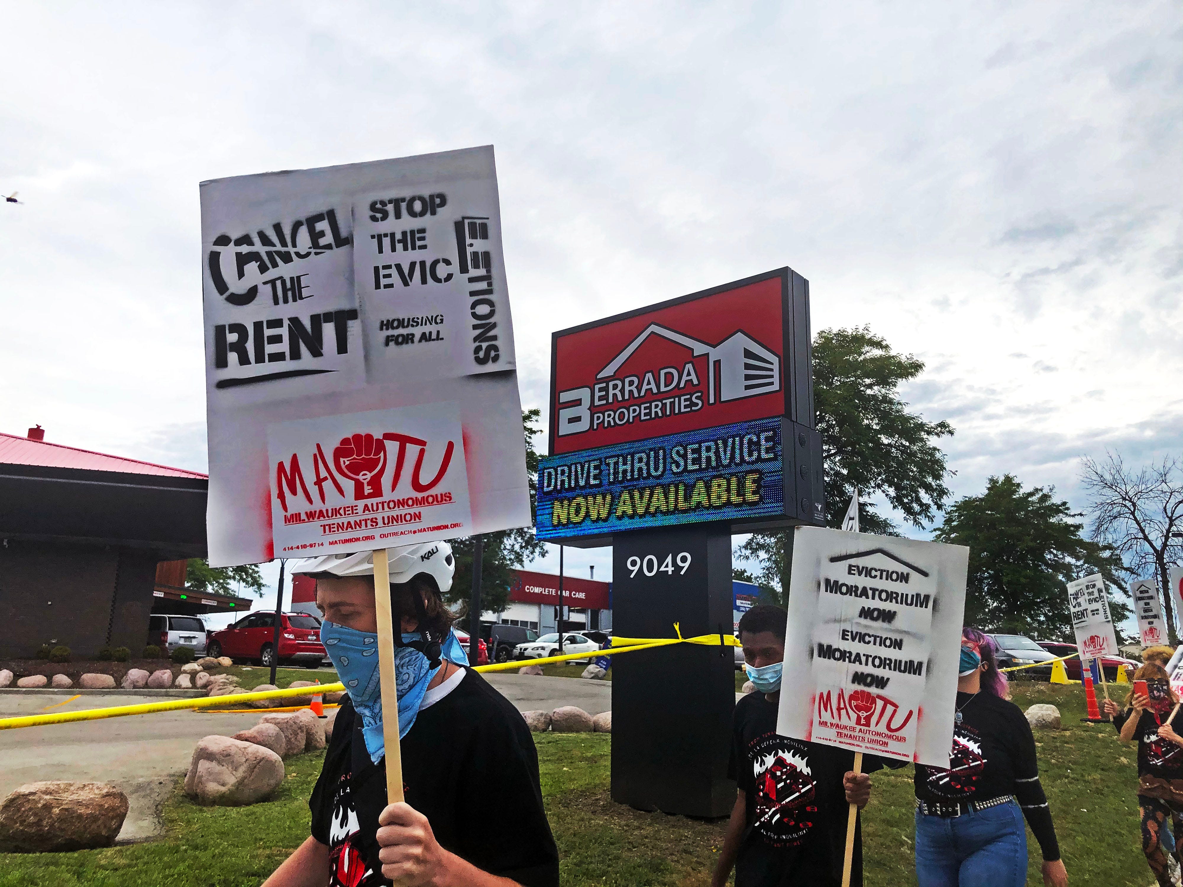 Two dozen protesters picket outside Berrada Properties, 9049 N. 76th St., Milwaukee, over owner Youssef "Jo" Berrada's high eviction rates. Berrada, known as the "boulder guy" because his trademark boulders are usually placed in front of his properties,  is responsible for one out of every 10 evictions in the city. The millionaire property owner has a three-lane drive-up service where tenants can pay their rent. On Sept. 1, there was a steady stream of tenants paying their rent sometimes five cars deep in each of the three rows. Armed security guards patrolled the property.