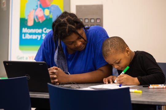 Trachelle Bivins and her 5-year-old son, Ondrae Florence, complete his school work together at Central Library of Rochester on Tuesday, Sept. 29, 2020. Ondrae would have attended school at School 23, part of the Rochester City School District, if the district had not moved to online learning. Ondrae and his mom have internet at home, but choose to come to the library because it creates a better learning environment for him.