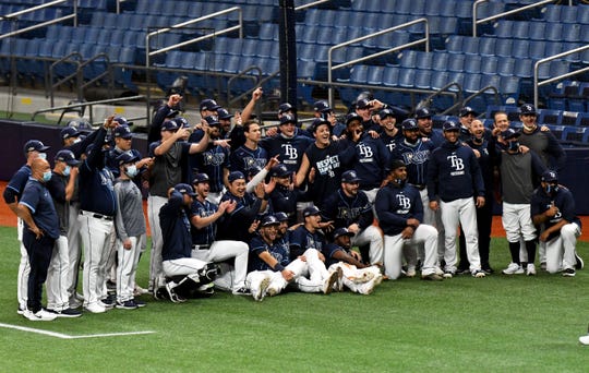 Rays players celebrate on the field after winning Game2..