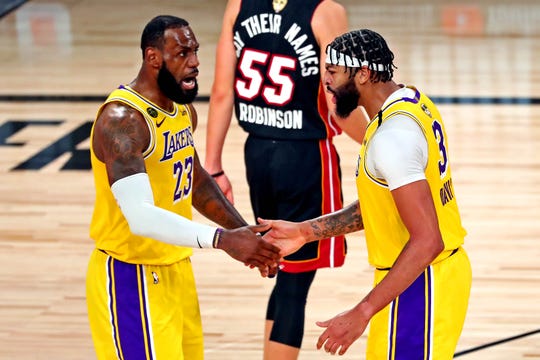 Lakers forwards LeBron James and Anthony Davis celebrate after a play in Game 1 of the NBA Finals.