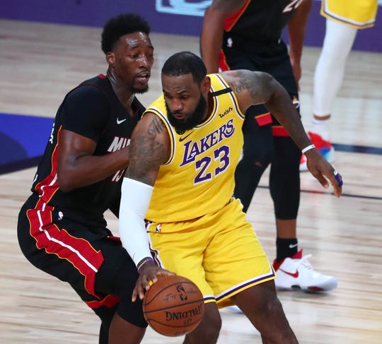 Los Angeles Lakers forward LeBron James (23) and Miami Heat forward Bam Adebayo battle during Game 1 of the NBA Finals.