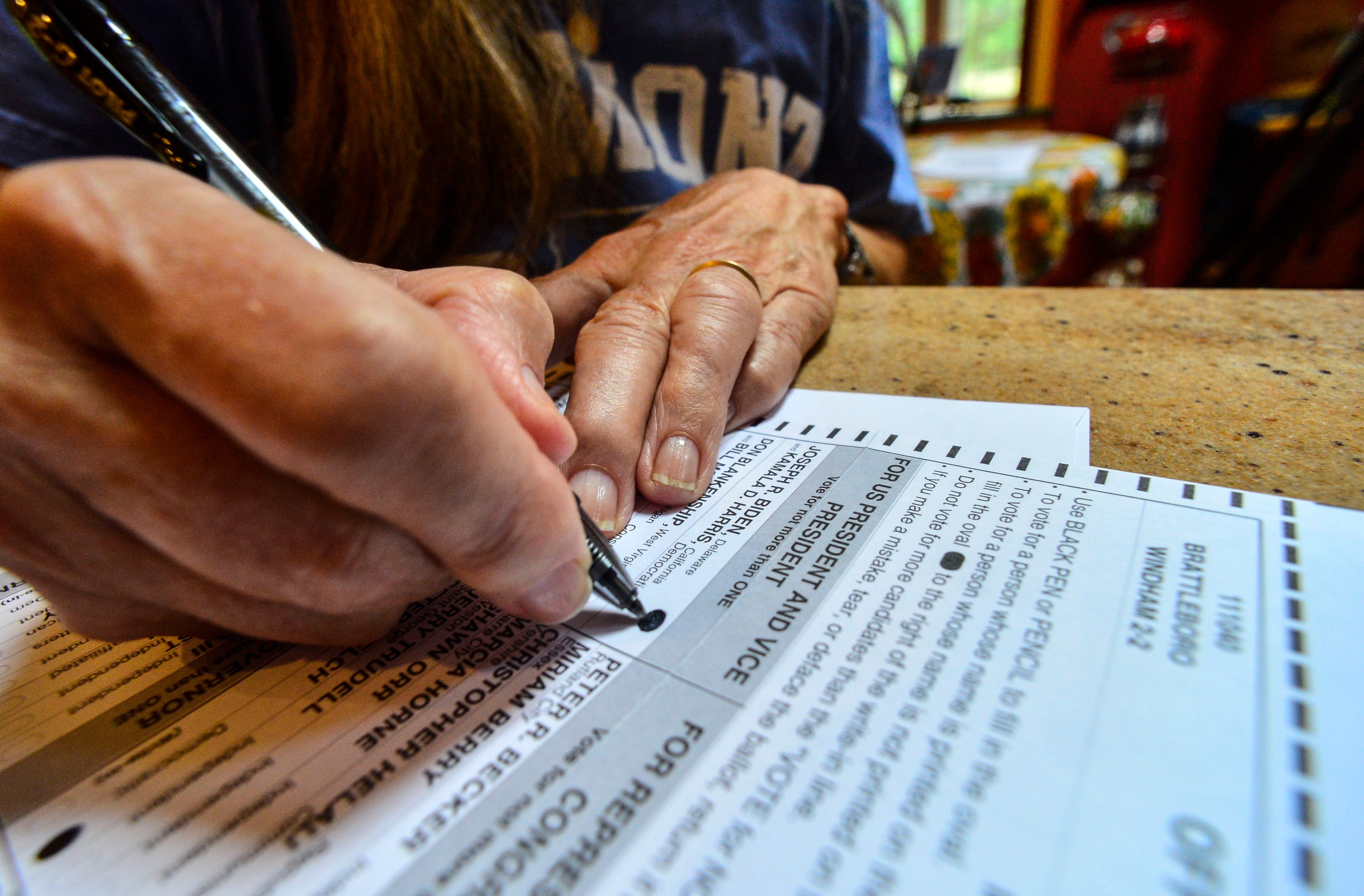 Susan Avery, of Brattleboro, Vt., casts her vote for Democrat presidential candidate, Joe Biden, while filling out her November election ballot that she received in the mail on Monday, Sept. 28, 2020.