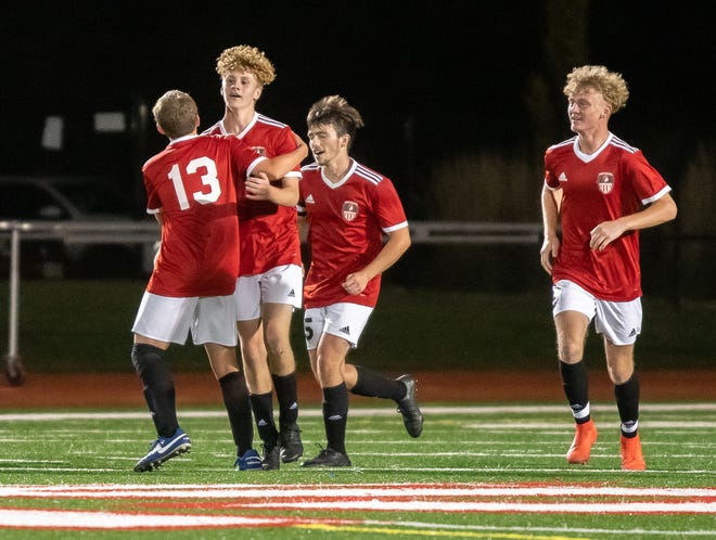 Fort Osage sophomore forward Lucca Smith is congratulated by teammate Xavier Steele (13) after scoring one of his two goals in Thursday's 3-2 win over rival William Chrisman.