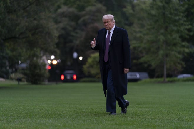 President Donald Trump gives the thumbs-up Thursday as he walks from Marine One to the White House in Washington, as he returns from Bedminster, N.J.