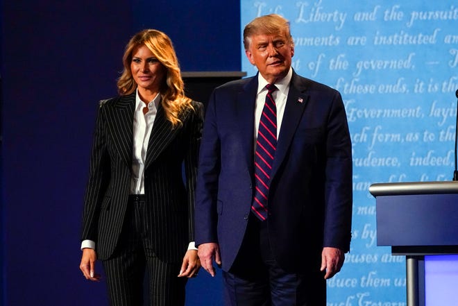 President Donald Trump stands on stage with first lady Melania Trump after the first presidential debate with Democratic presidential candidate former Vice President Joe Biden Tuesday, Sept. 29, 2020, at Case Western University and Cleveland Clinic, in Cleveland, Ohio. President Trump and first lady Melania Trump have tested positive for the coronavirus, the president tweeted early Friday. (AP Photo/Julio Cortez)