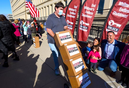 Boxes filled with a reported 539,384 petition signatures are delivered by Unlock Michigan to the Michigan Department of State Bureau of Elections in Lansing Friday, October 2, 2020. The group is seeking to revoke Governor Gretchen Whitmer's ability to govern by emergency decree.