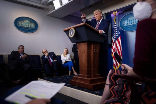 Former New Jersey Governor Chris Christie, former New York City Mayor Rudy Giuliani, White House Press Secretary Kayleigh McEnany, and others listen while US President Donald Trump answers questions during a briefing at the White House Sept. 27, 2020, in Washington, DC.