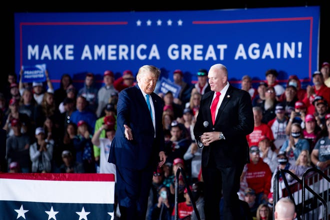 US President Donald Trump and National President of the Fraternal Order of Police Patrick Yoes speak during a "Make America Great Again" campaign rally at Harrisburg international airport in Middletown, Pennsylvania.