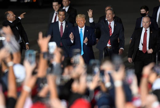 President Donald Trump, center, arrives at a campaign rally at Harrisburg International Airport, Sept. 26, 2020, in Middletown, Pa.