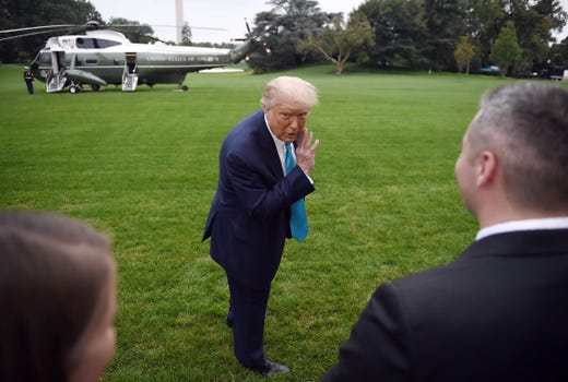President Trump whispers to a White House staffer as he makes his way to board Marine One from the South Lawn of the White House in Washington, DC on Sept. 26, 2020.