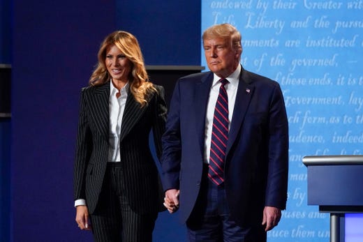 President Donald Trump and first lady Melania Trump hold hands on stage after the first presidential debate at Case Western University and Cleveland Clinic, in Cleveland, Ohio on Sept. 29, 2020. 