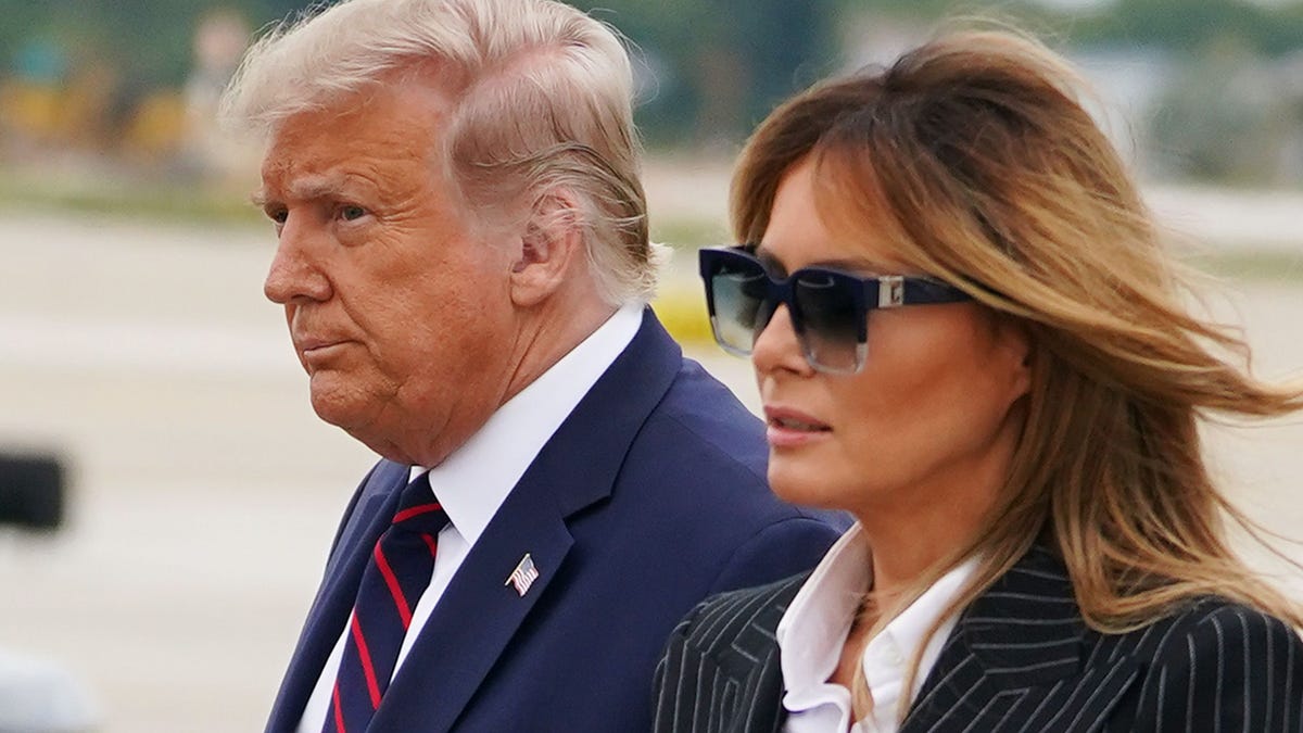 A September 29, 2020 photo shows US President Donald Trump and First Lady Melania Trump  upon arrival at Cleveland Hopkins International Airport in Cleveland, Ohio where Trump will be taking part in the first presidential debate.