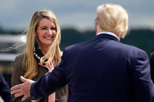 President Donald Trump greets Sen. Kelly Loeffler, R-Ga., as he arrives at Dobbins Air Reserve Base for a campaign event at the Cobb Galleria Centre, Friday, Sept. 25, 2020, in Atlanta.