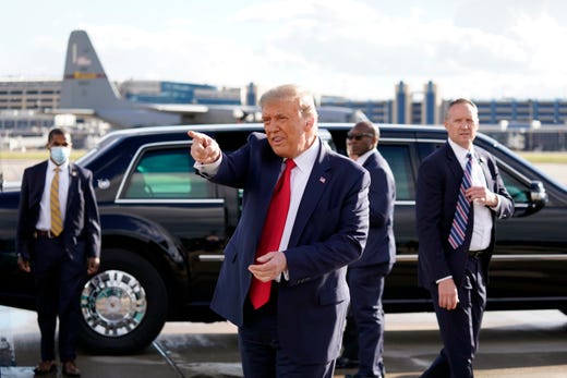 President Donald Trump gestures to supporters as he arrives at Minneapolis Saint Paul International Airport, Sept. 30, 2020, in Minneapolis. 