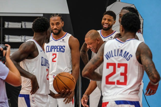 The Clippers' Kawhi Leonard, 2, Paul George, smiling, and coach Doc Rivers share a laugh on media day.