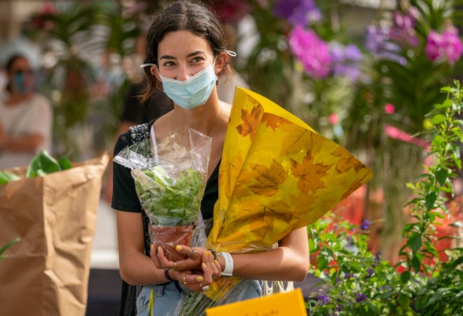 Abbi Michaeli bought a plant and some flowers during the opening of West Palm Beach?s GreenMarket in West Palm Beach, Florida on October 3, 2020.