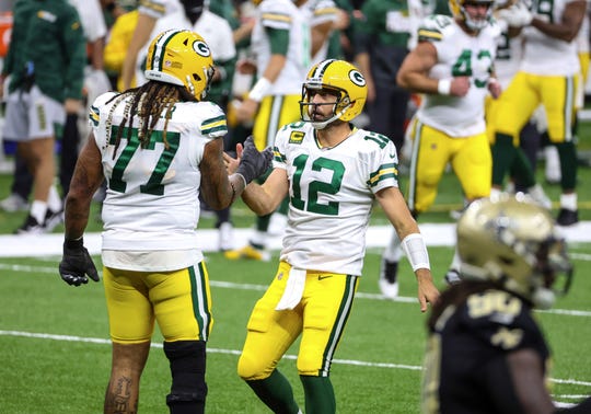 Green Bay Packers quarterback Aaron Rodgers (12) celebrates with guard Billy Turner (77) after a touchdown against the New Orleans Saints during the second quarter at the Mercedes-Benz Superdome.