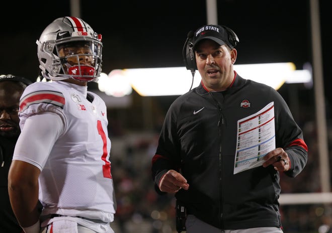 Ohio State Buckeyes quarterback Justin Fields (1) talks to head coach Ryan Day during the first quarter of the NCAA football game against the Northwestern Wildcats at Ryan Field in Evanston, Ill. on Friday, Oct. 18, 2019. [Adam Cairns/Dispatch]