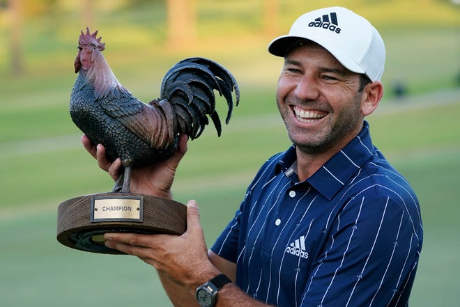 Sergio Garcia, of Spain, holds the Sanderson Farms Championship trophy after winning the PGA tournament in Jackson, Miss., on Sunday.