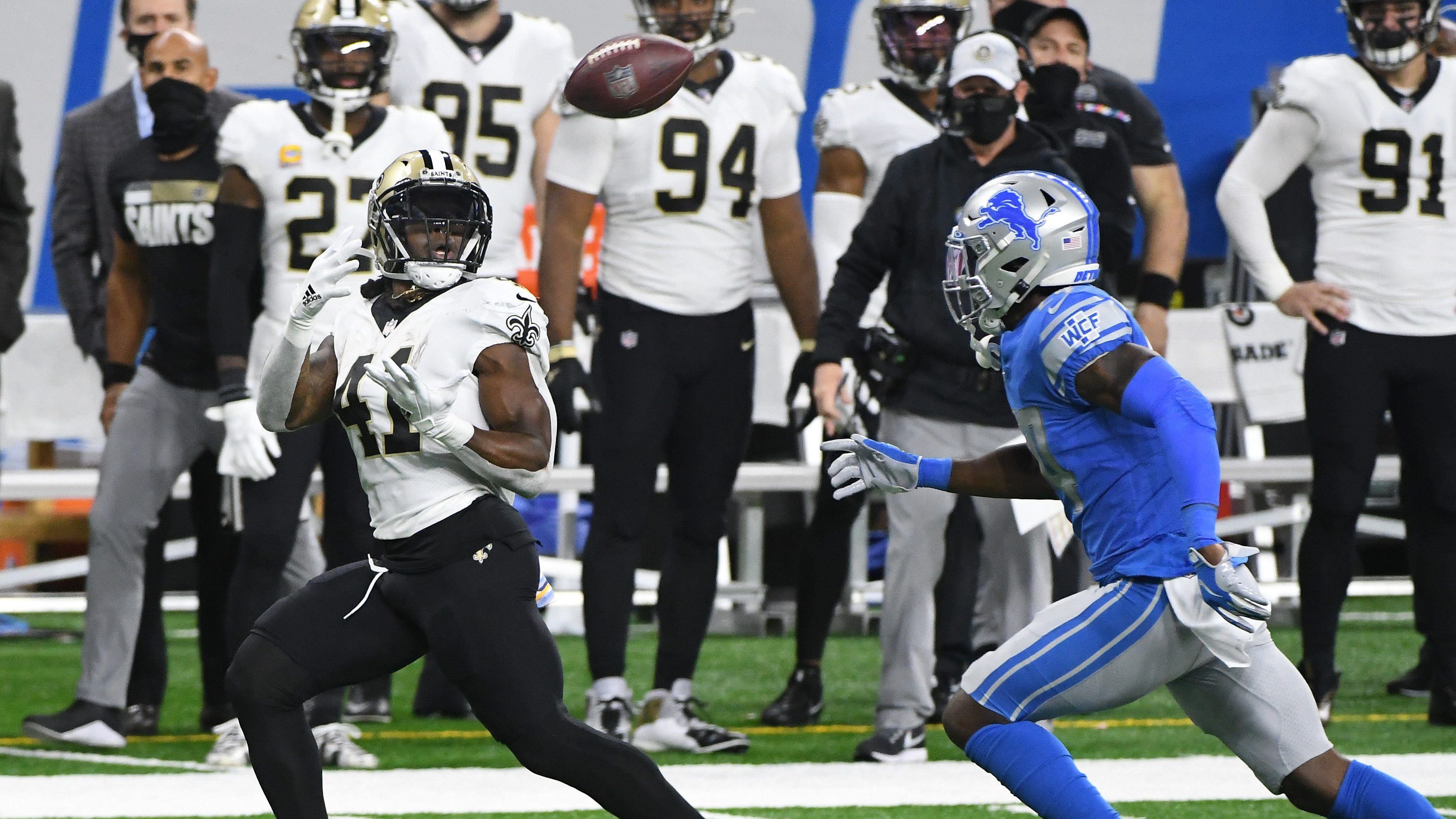 Saints running back Alvin Kamara readies for a long reception in front of Lions safety Will Harris in the second quarter Sunday at Ford Field.