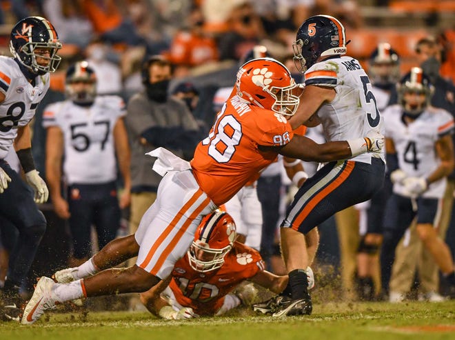 Clemson defensive end Myles Murphy(98) tackles Virginia quarterback Brennan Armstrong(5) during the third quarter of the game Saturday, October 3, 2020 at Memorial Stadium in Clemson, S.C.