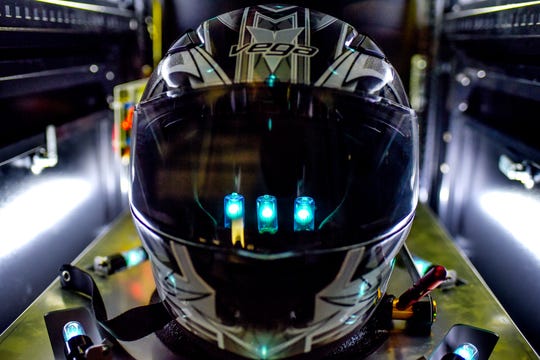 A helmet is cleaned with infrared light in a helmet sanitation machine on Monday, Oct. 5, 2020, at High Caliber Karting and Entertainment in the Meridian Mall in Meridian Charter Township. 