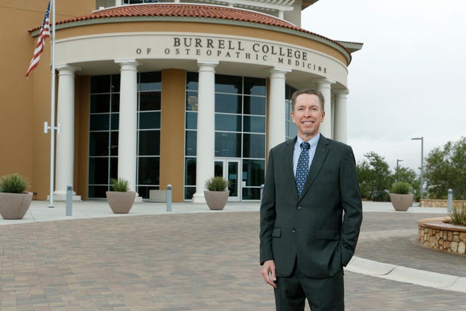 William Pieratt, the Dean and Chief Academic Officer of the Burrell College of Osteopathic Medicine, stands outside the college entrance, located on the campus of New Mexico State University in Las Cruces, N.M.